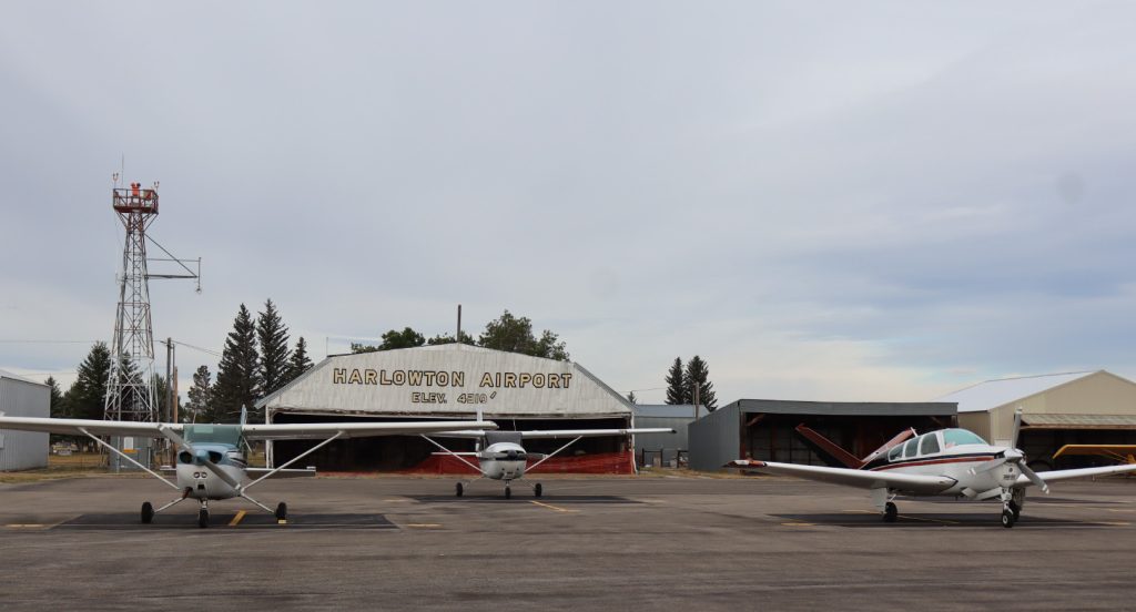 three planes parked at the harlowton airport